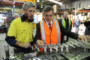 OzPress tool room manager Damien Ferguson shows Victoria Premier John Brumby his station.