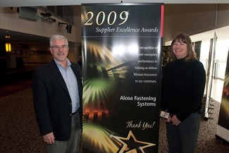 AFS sales director Lisa Robertson and Roy Fava, Account Manager for AFS Simi Valley, accept a Supplier Excellence Award from Raytheon