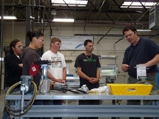 Washington Aerospace Training and Research Center students get a lesson in aluminum drilling techniques from facilitator Alex McEwen. (Photo courtesy Snohomish County Business Journal)